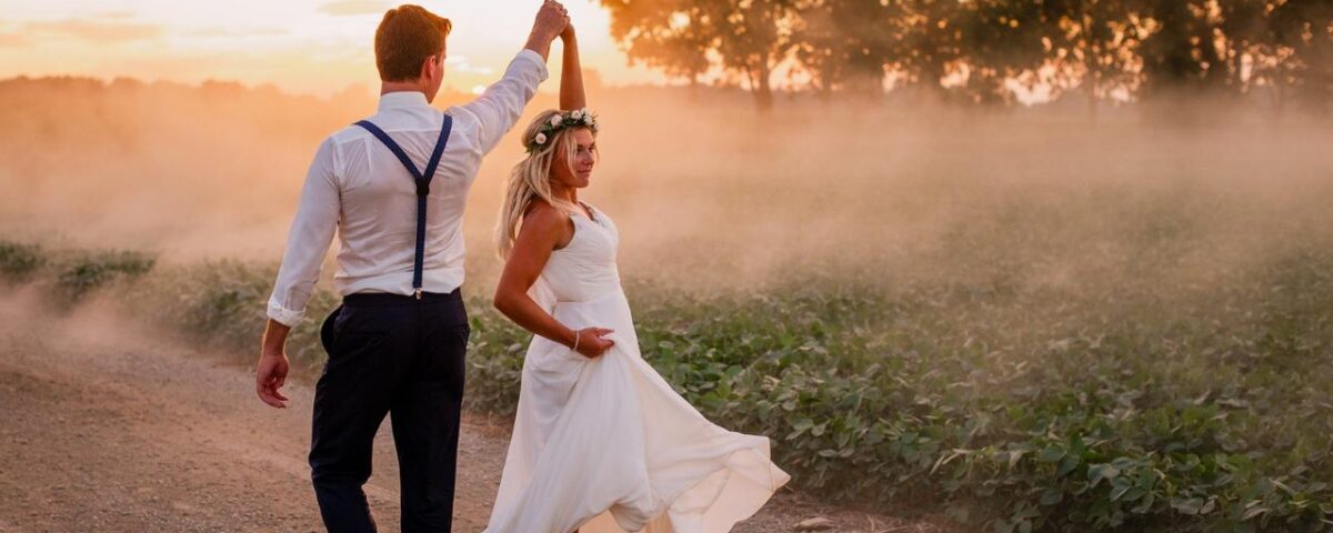 wedding photo of a couple walking in suburban road in golden hour