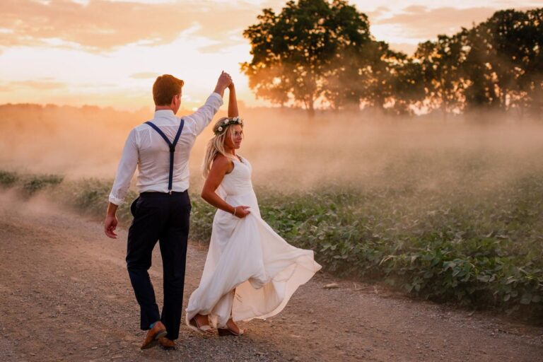 wedding photo of a couple walking in suburban road in golden hour