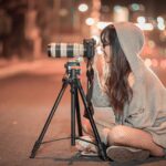 a girl working with her camera and doing street photography
