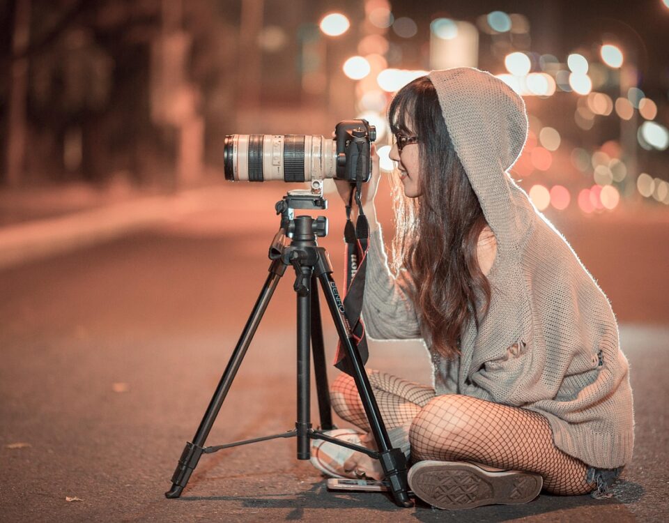 a girl working with her camera and doing street photography