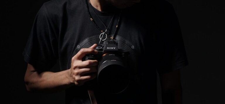 A man holding his professional camera in his hand