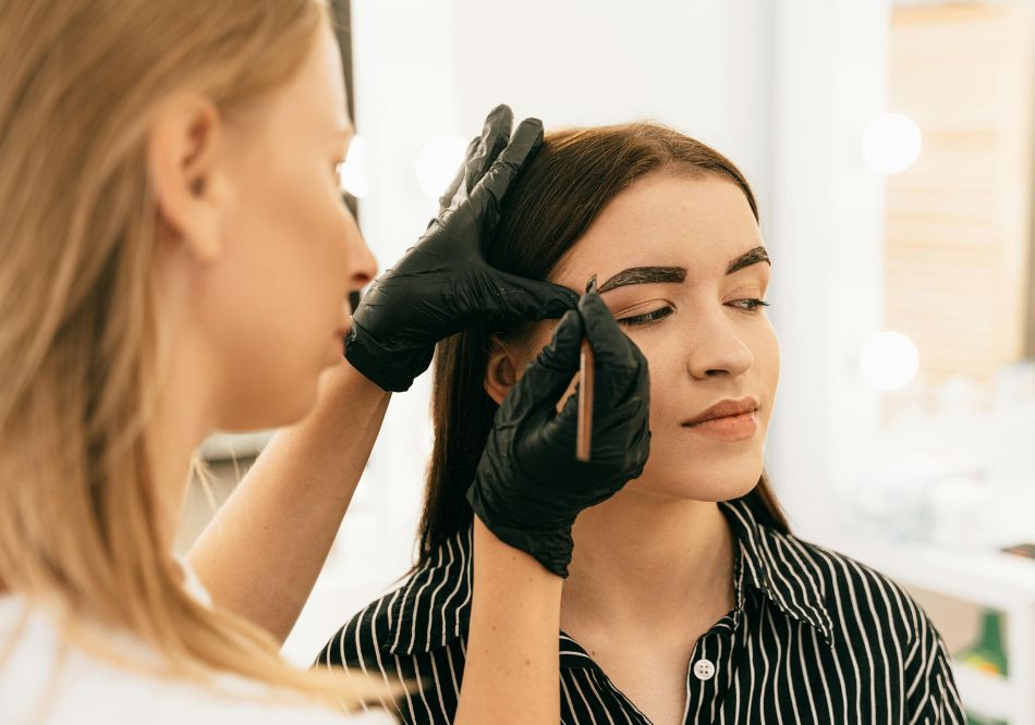 A woman doing makeup for another woman