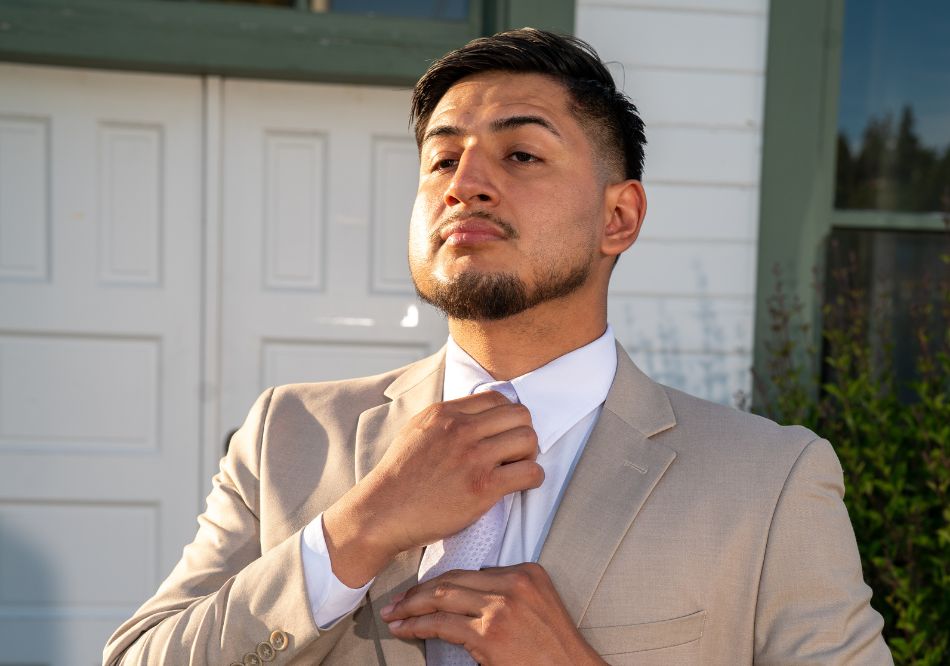 A confident man posing in front of the camera at his wedding