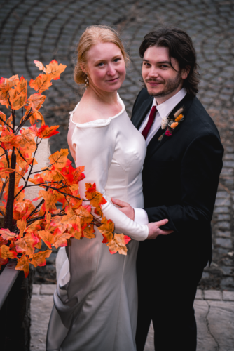 wedding photography of a couple in fall looking into the camera