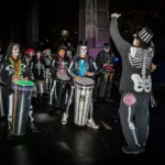 people with customs walking in a Halloween parade .