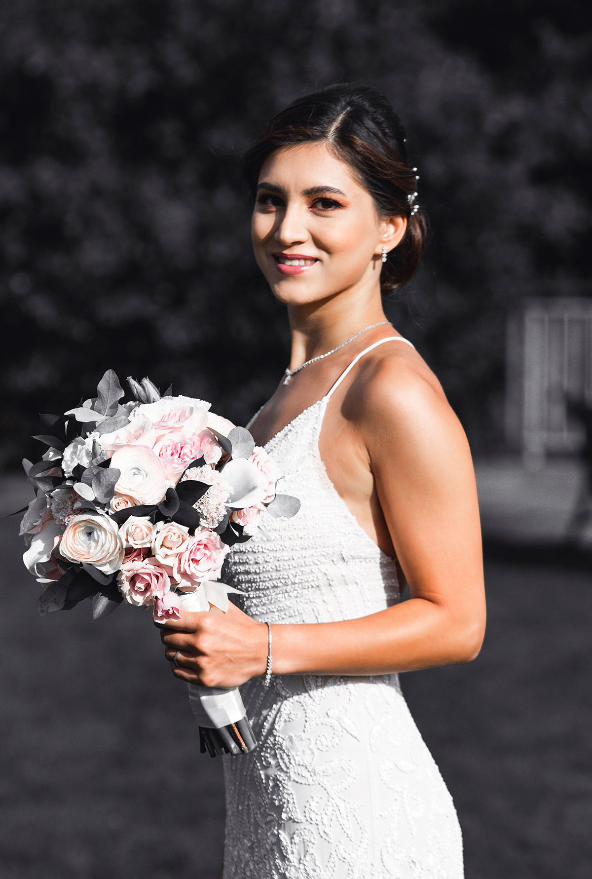 picture of a bride holding a flower in her hand in Seattle captured with f/1.8