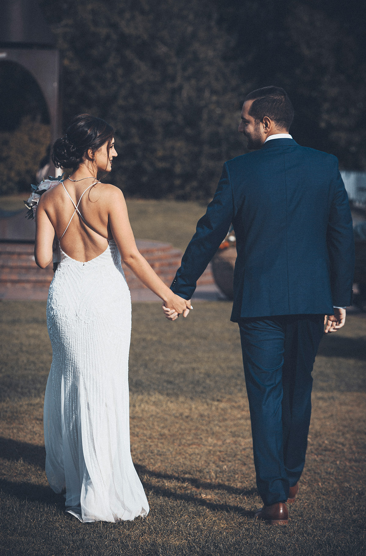 A vertical portrait of a couple holidng hands