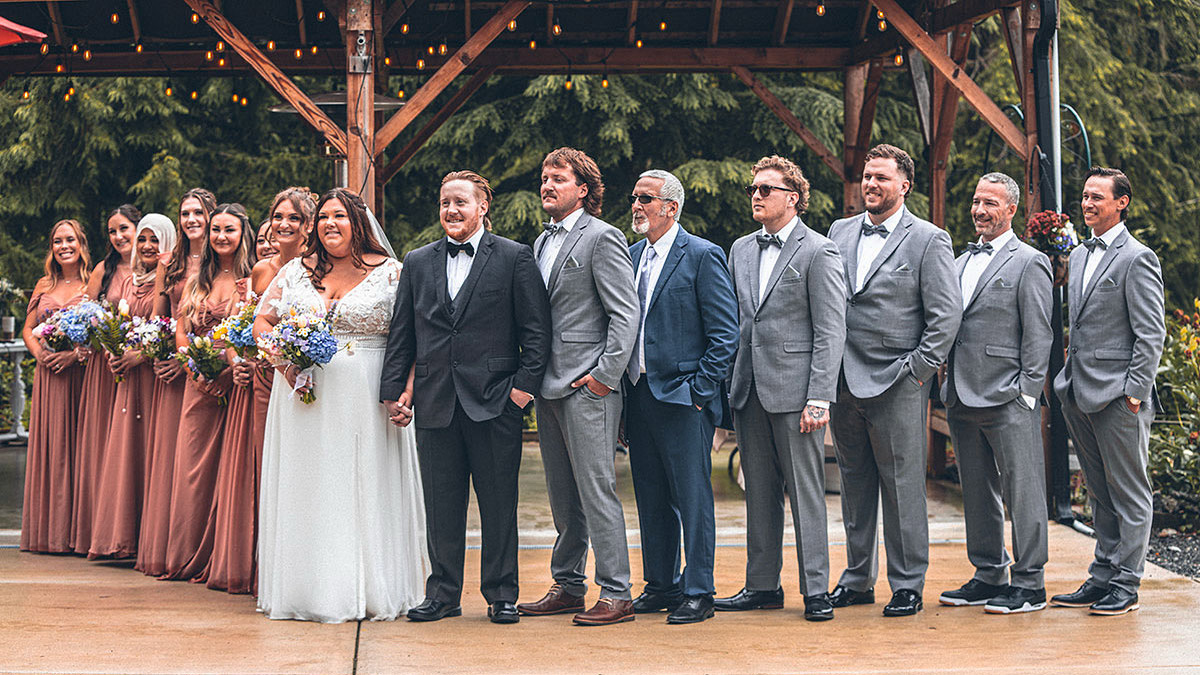 The bride and the groom standing with their friends