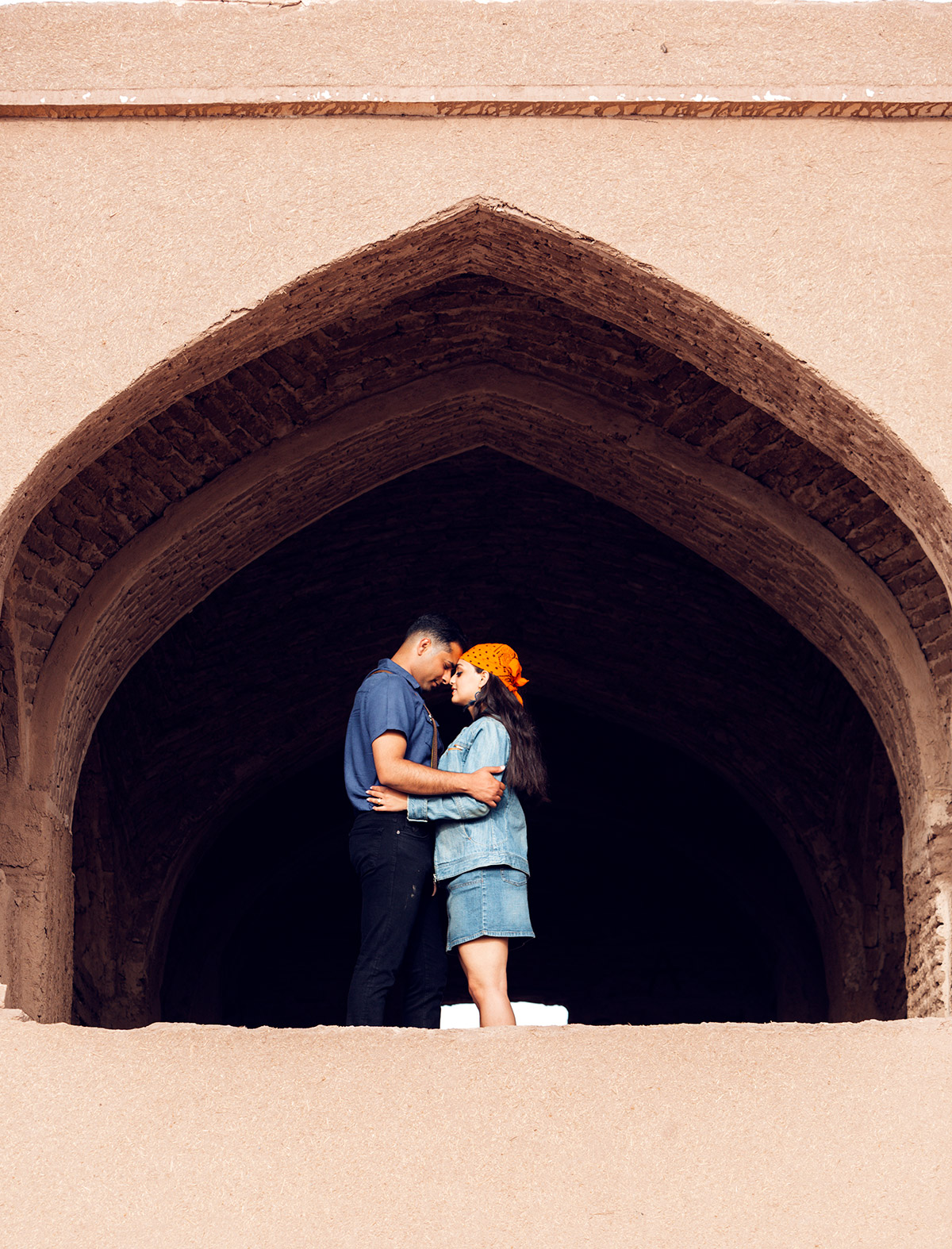 a couple holding each other in a historical site