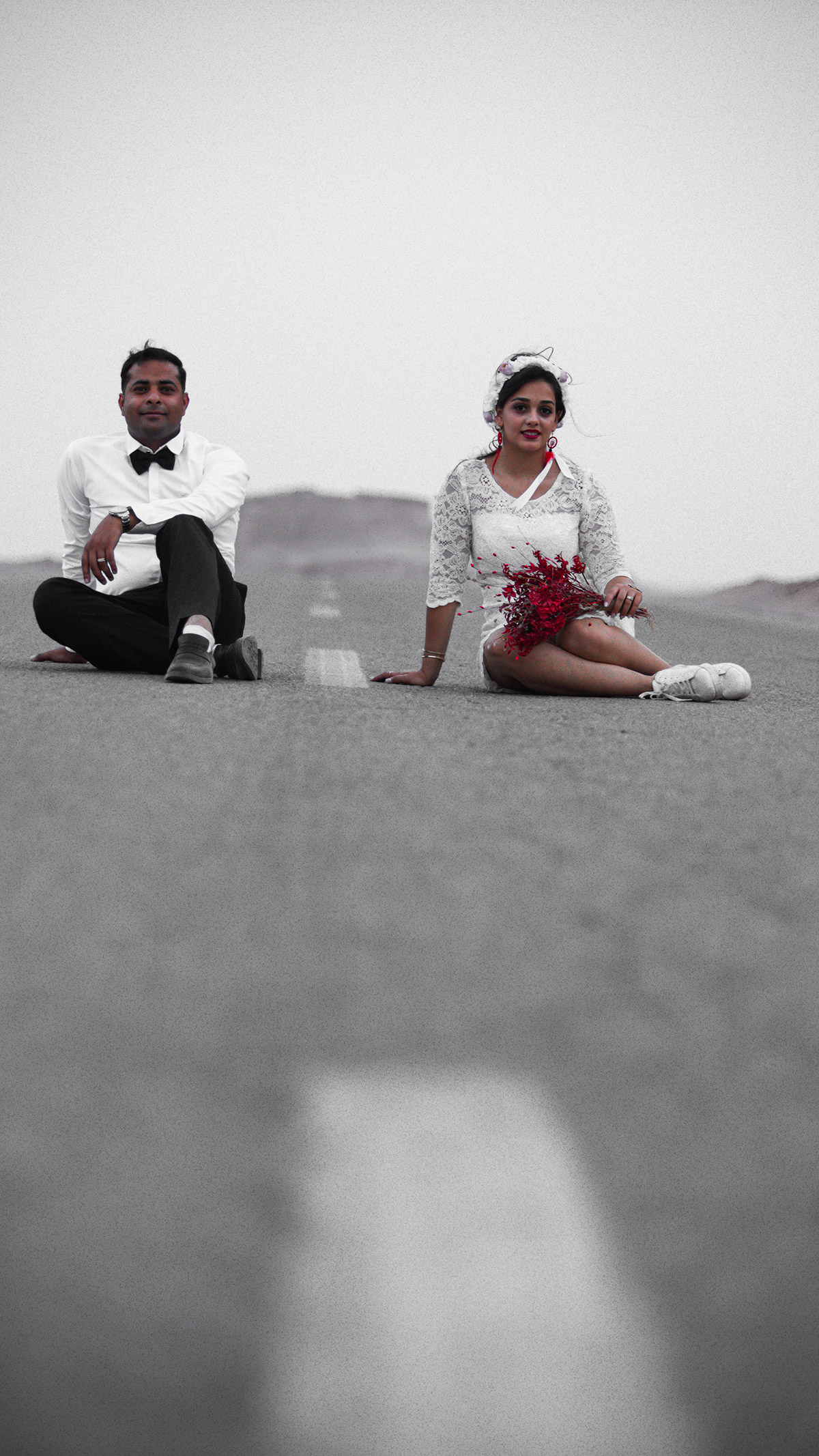 a couple sitting on the road in their engagement day
