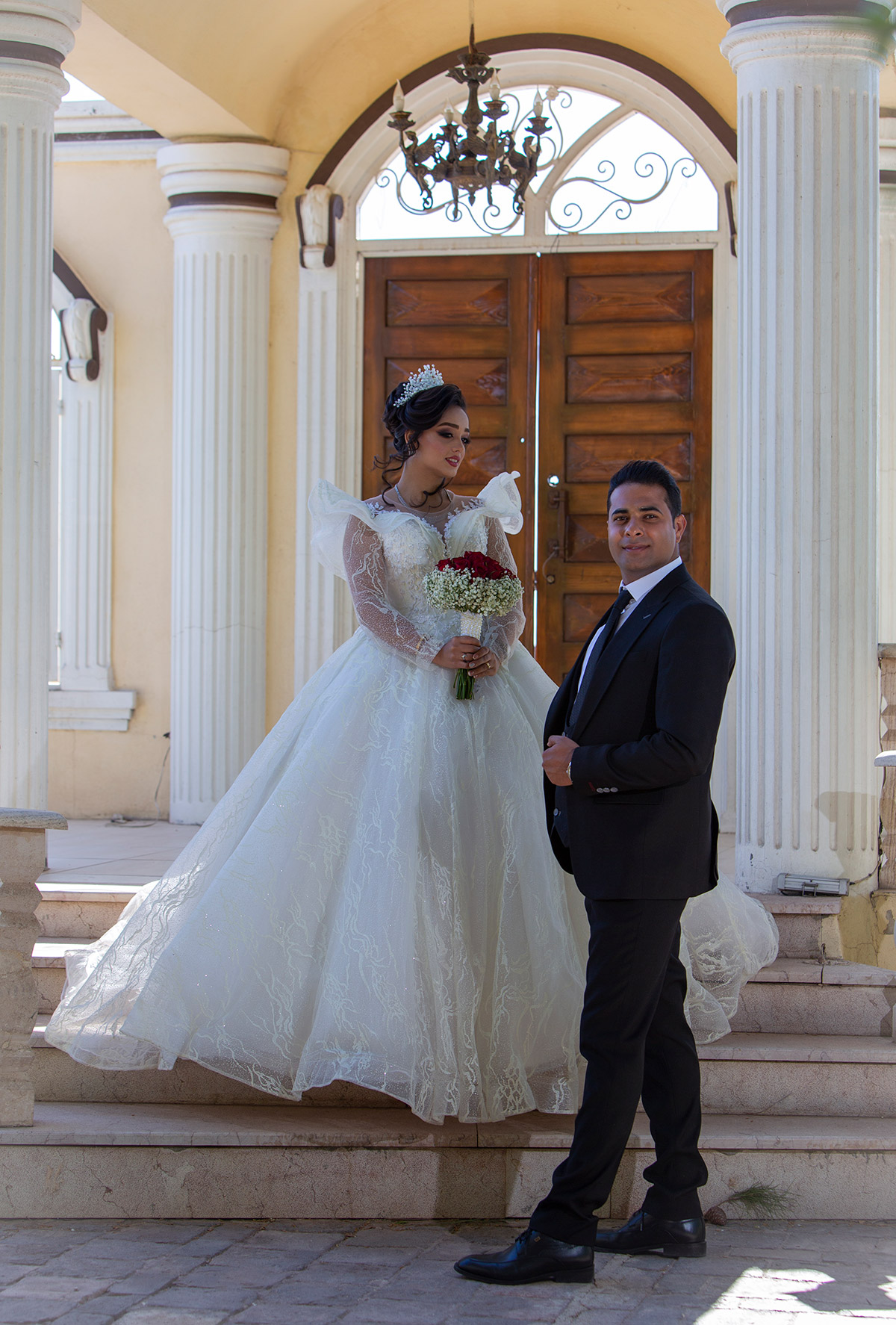 Wedding photo of a Persian couple on stairs