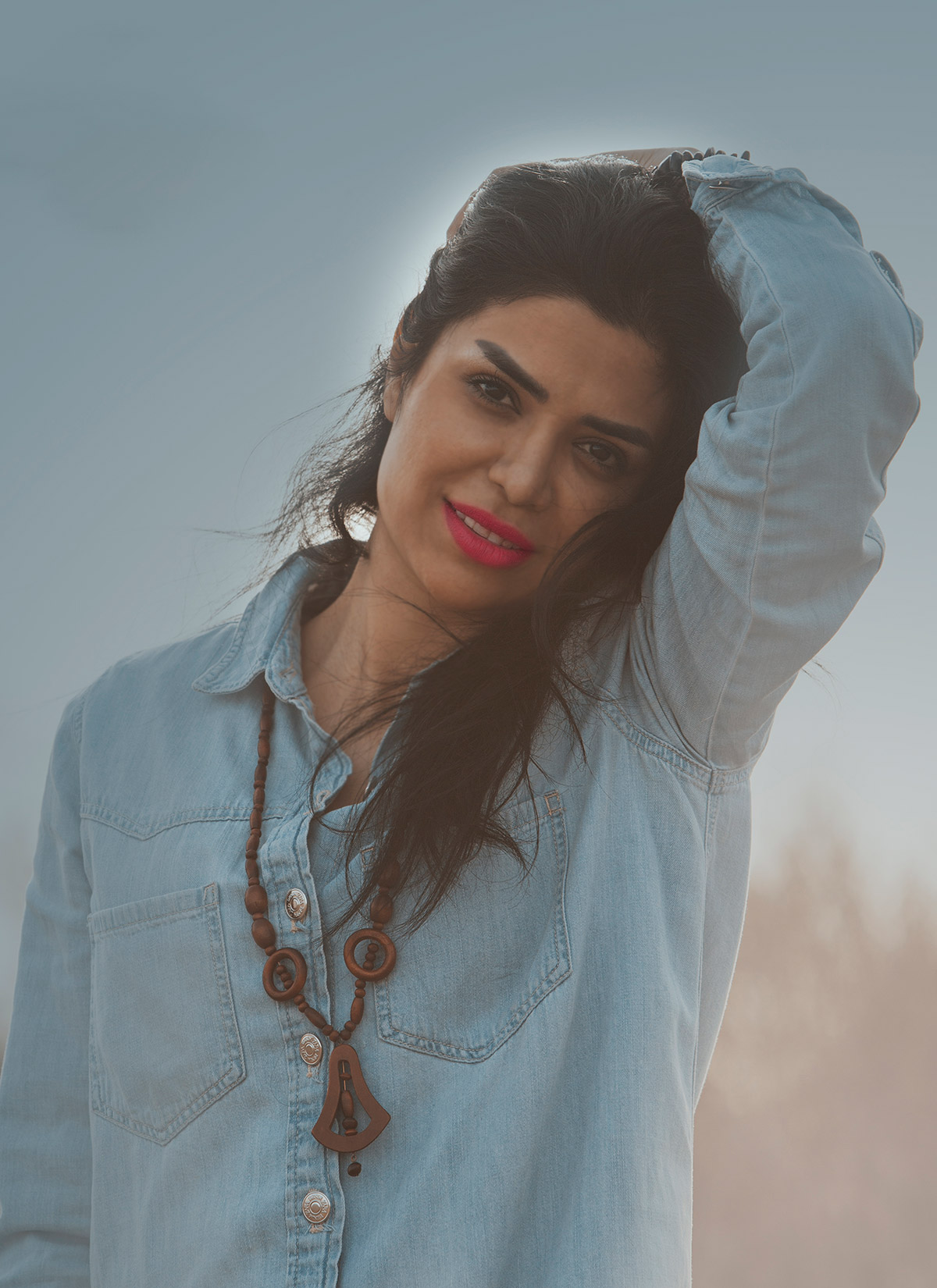 A close-up portrait of a woman with a professional pose.