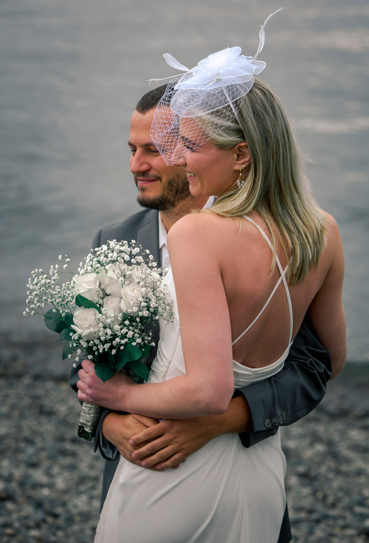 A close-up portrait of the bride and groom holding each other.