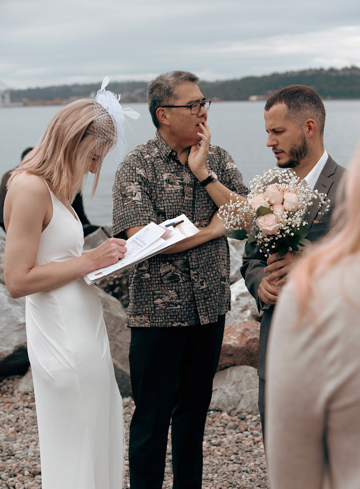 The bride signs her marriage document.