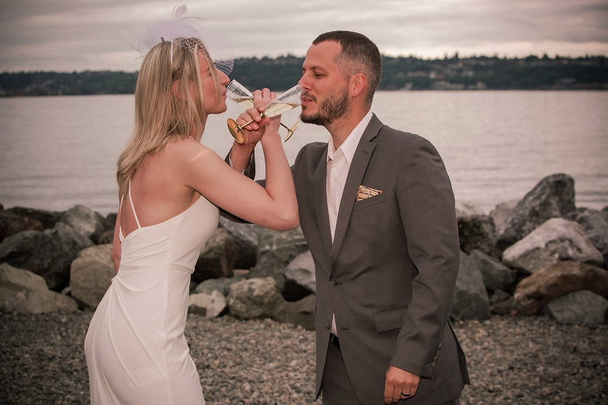 The bride and the groom are making a toast.