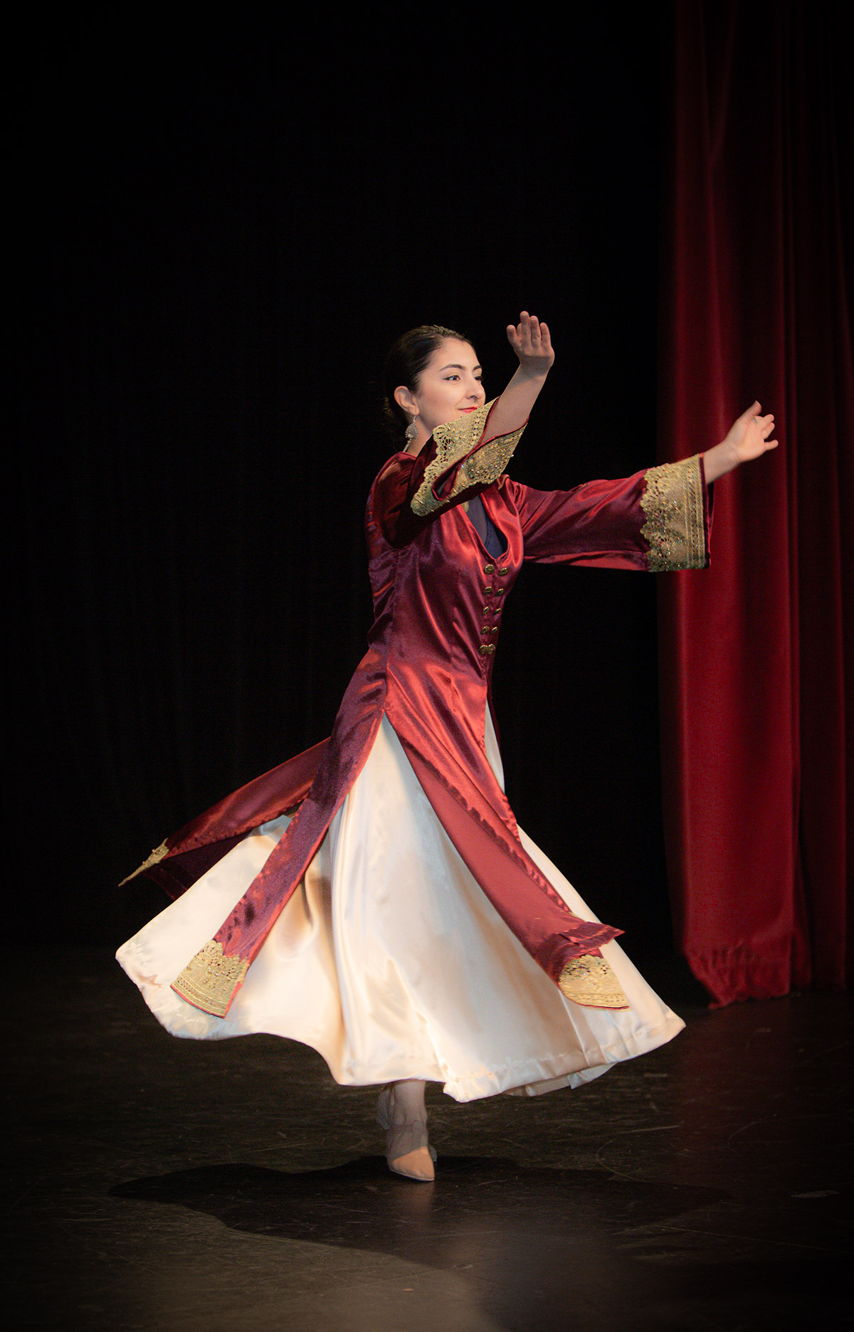 A woman in red dancing on stage