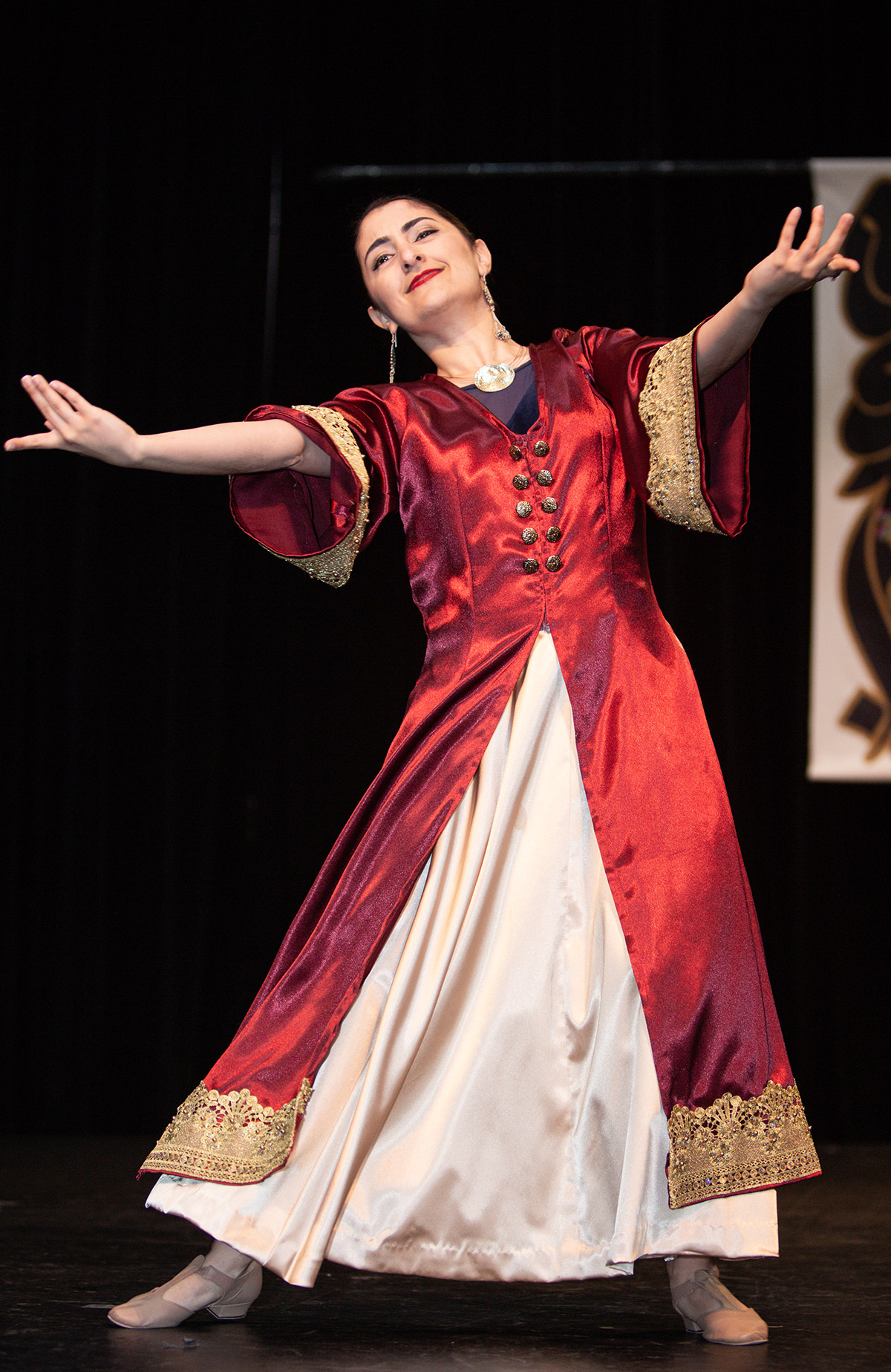 A woman in red dancing on stage