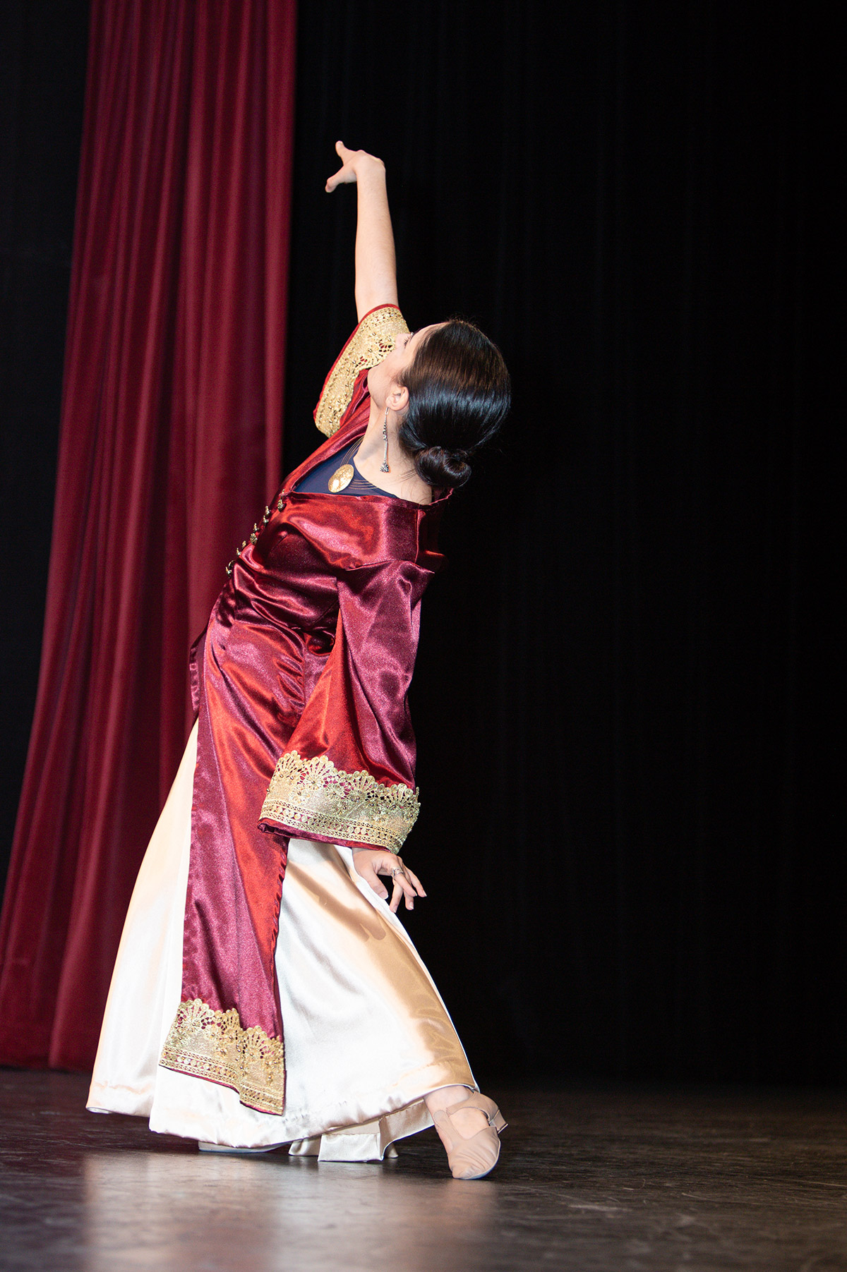 A woman in red dancing on stage