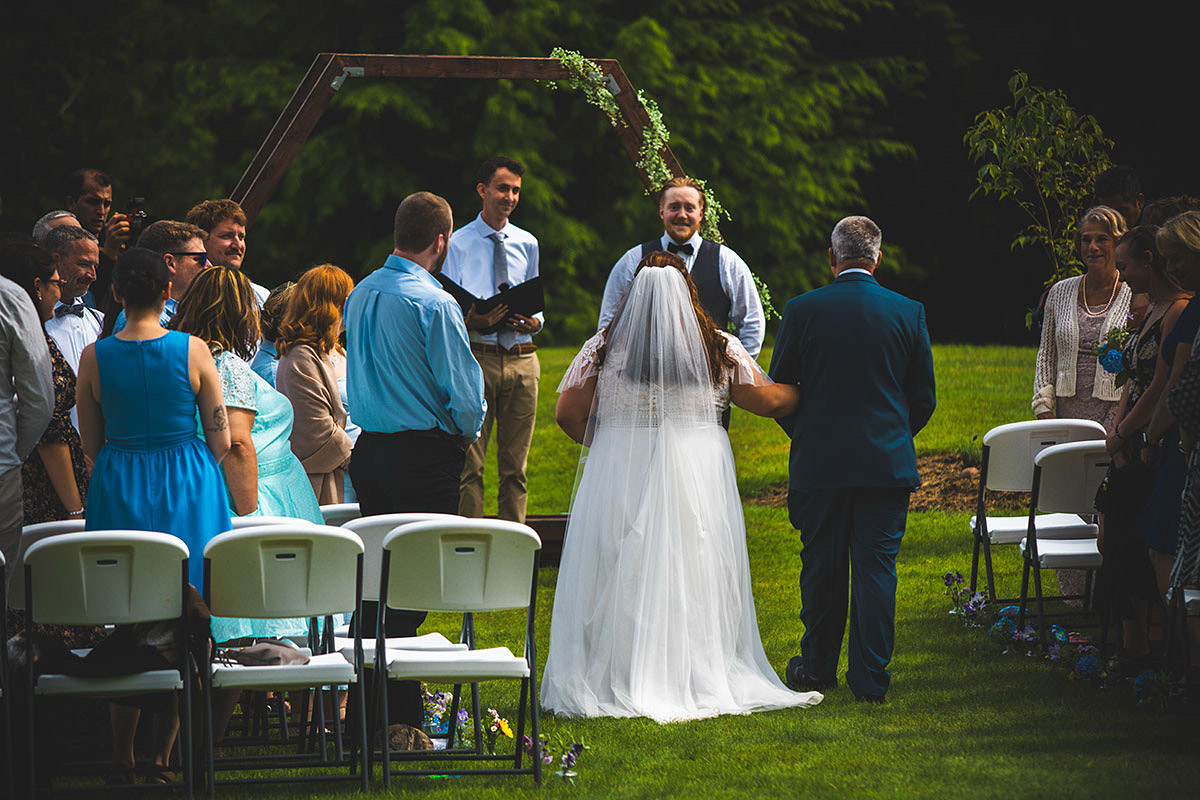 A beautiful photo of a couple's wedding day with the couples holding hands