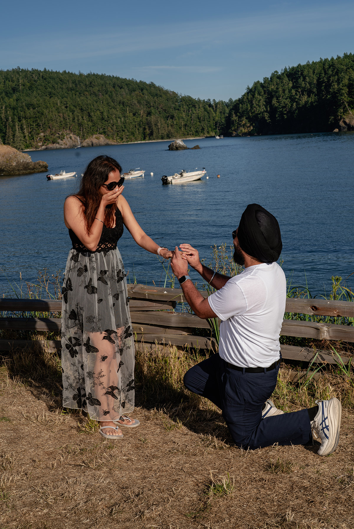 a man proposing to his partner on the shoreside