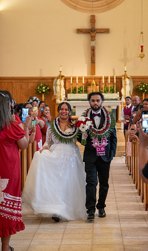Wedding photo of a couple walking down the aisle on their wedding day
