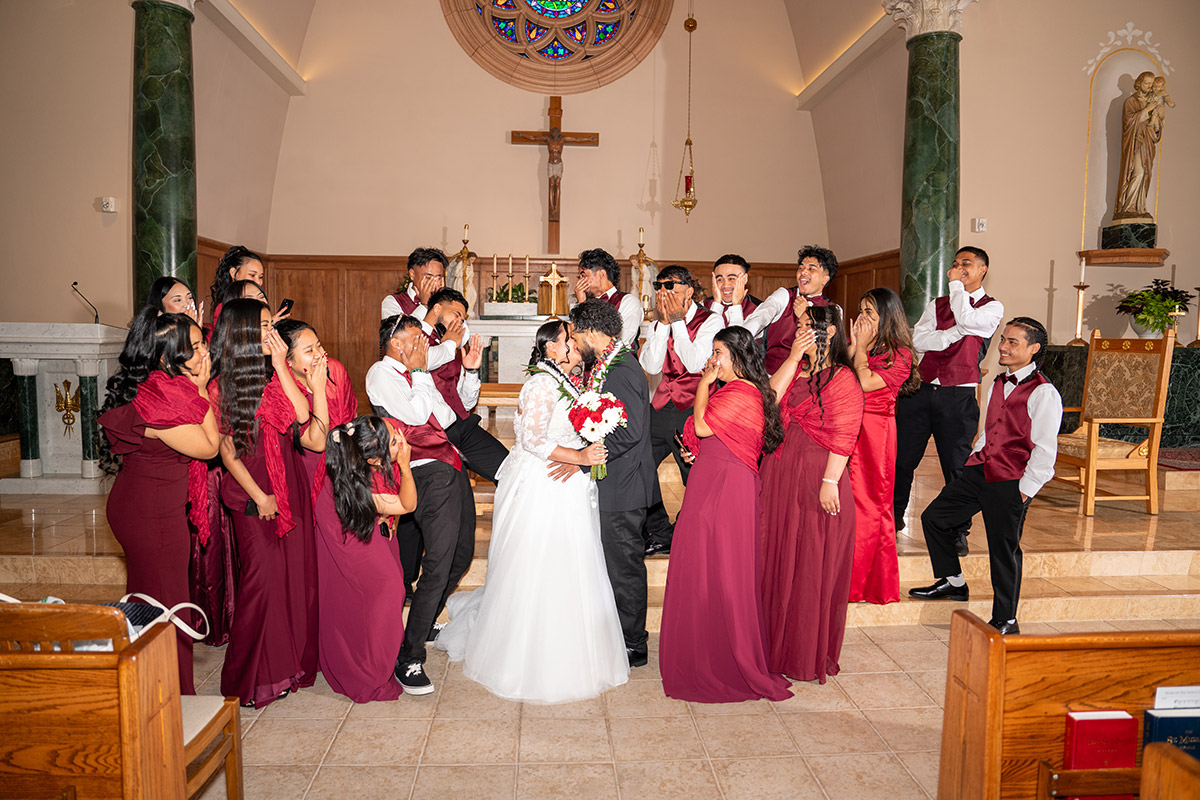 A wide photo of a couple and their wedding day in the church.