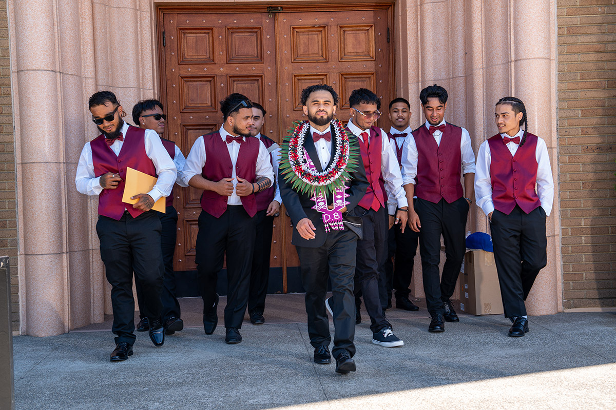 The groom walking with his wingmen.