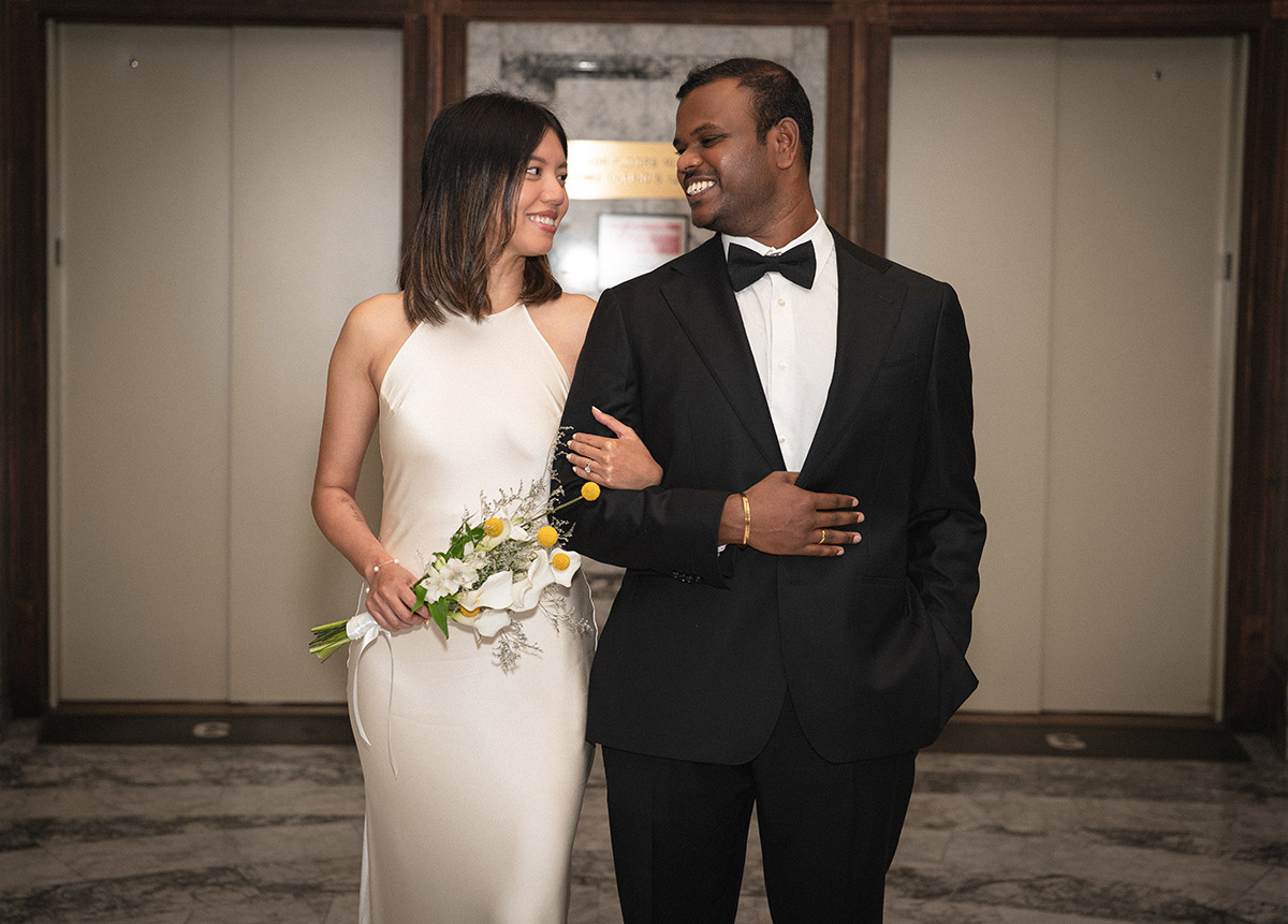 A portrait of a couple holding each other's hands