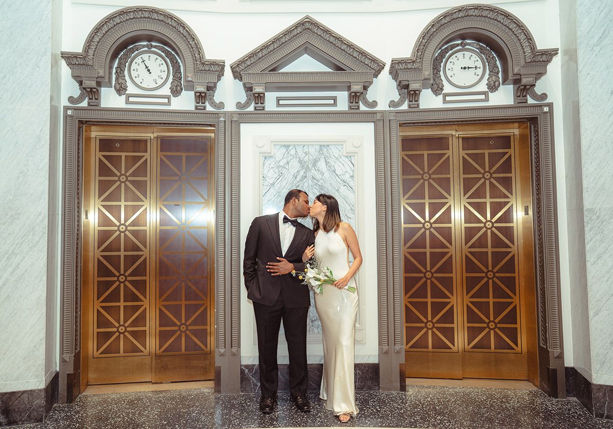 A couple kissing each othe in the city hall