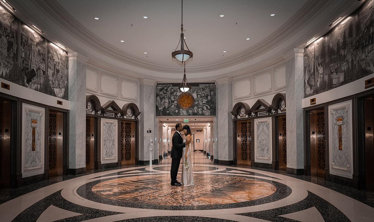 A wide photo of a couple kissing each other 