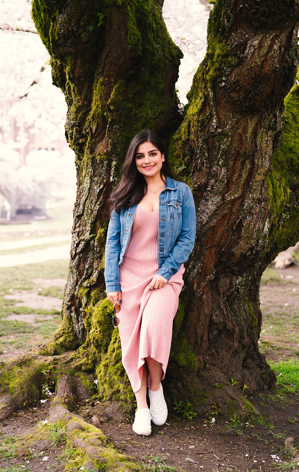 A beautiful portrait of a woman with a tree in the background 
