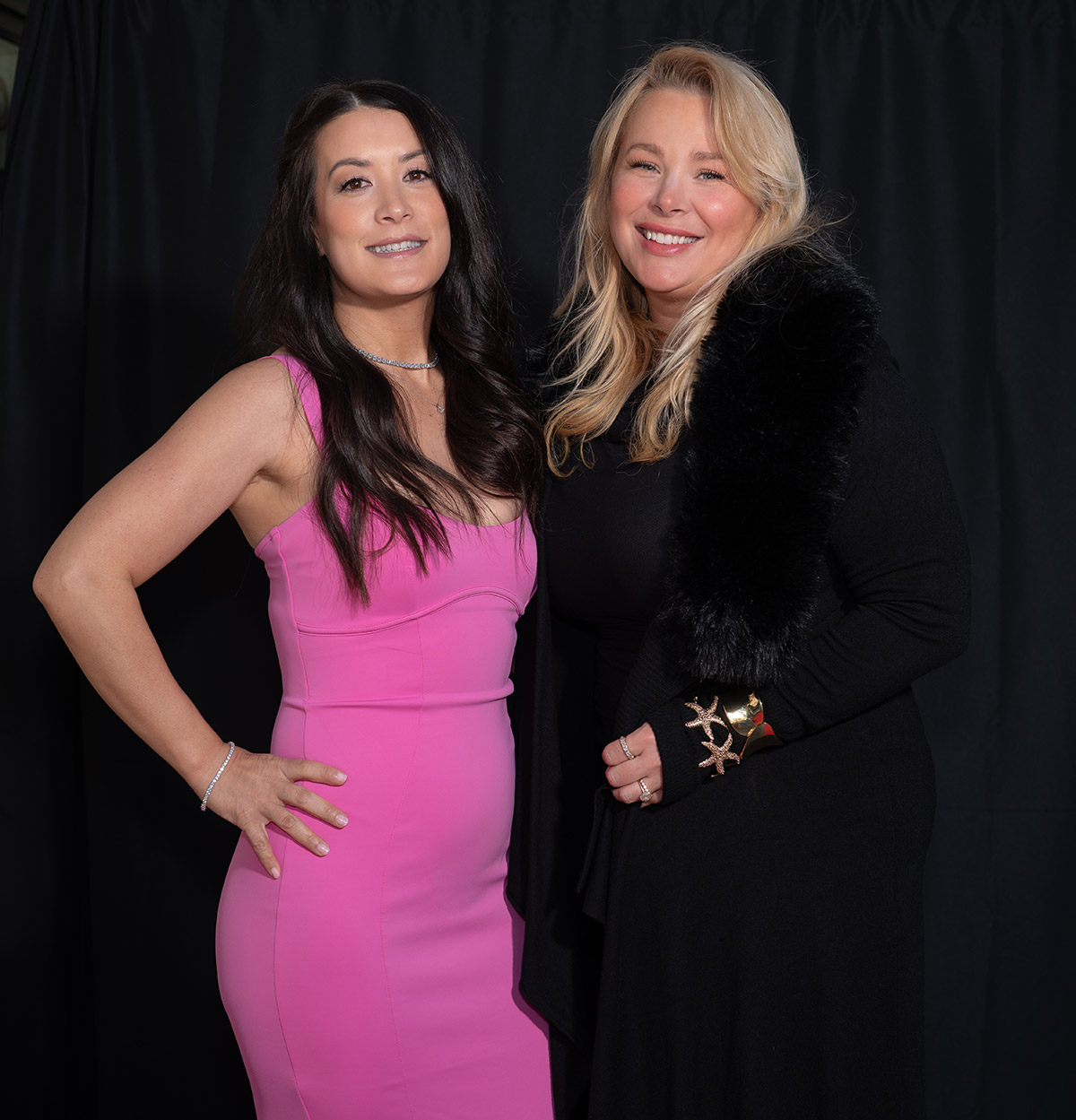 Two friends standing on a red carpet