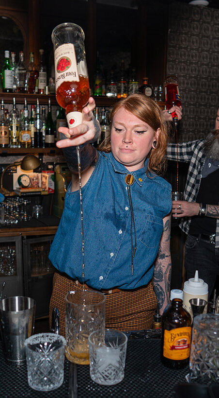 A bartender filling cups