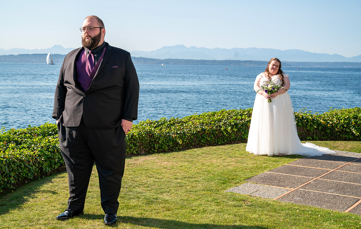 A portrait of a couple near a shore.