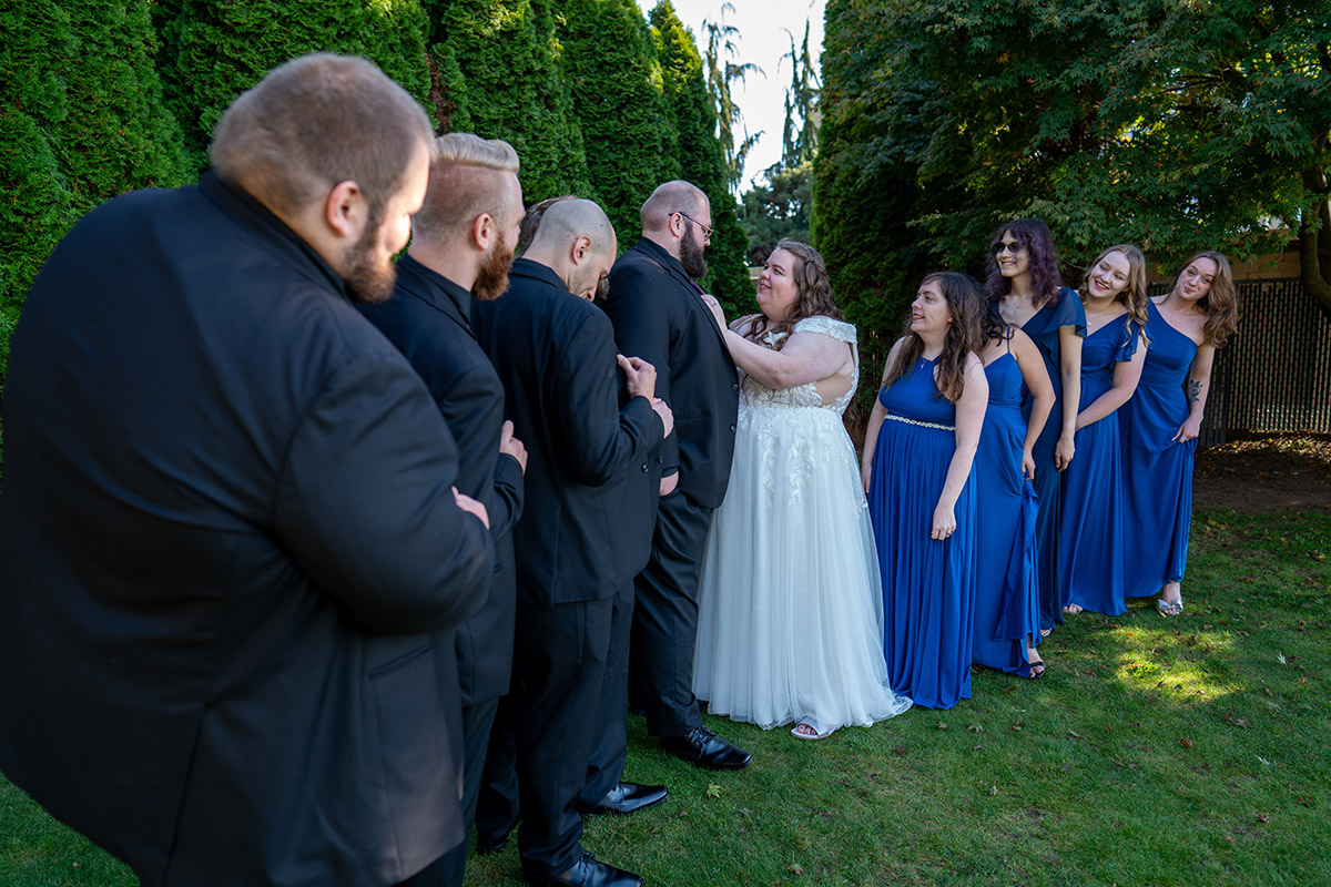 A photo of the bride, the groom, and their companies.