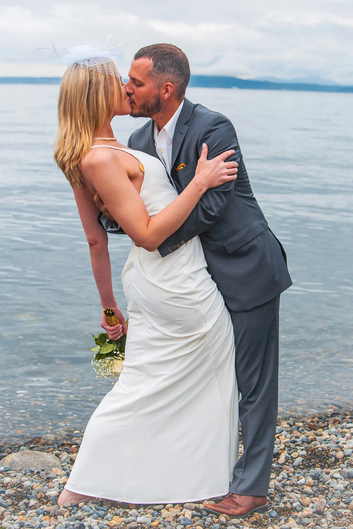 A wedding photo of a couple holding and kissing each other