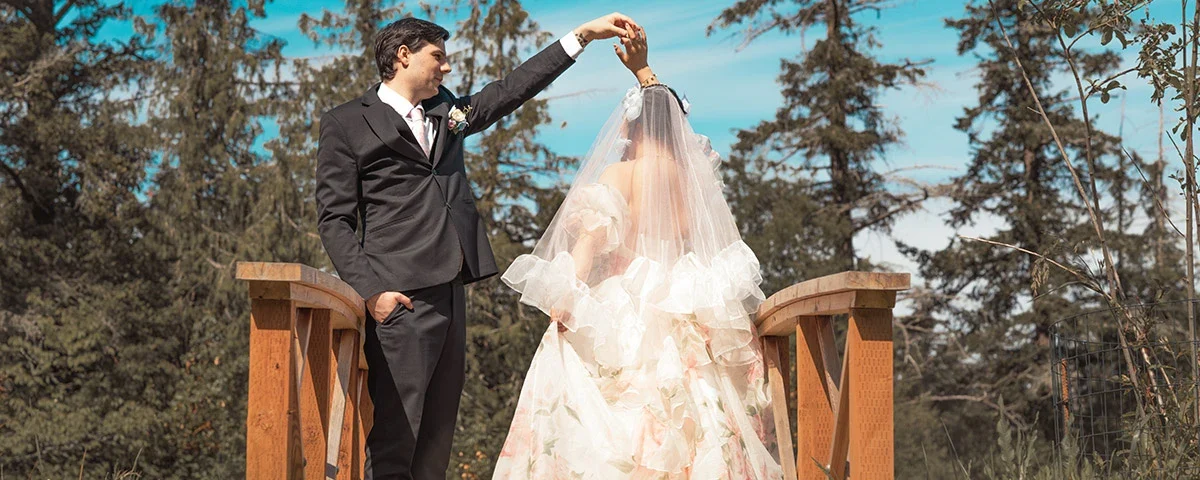 bride and groom dancing in on a bridge