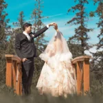 bride and groom dancing in on a bridge